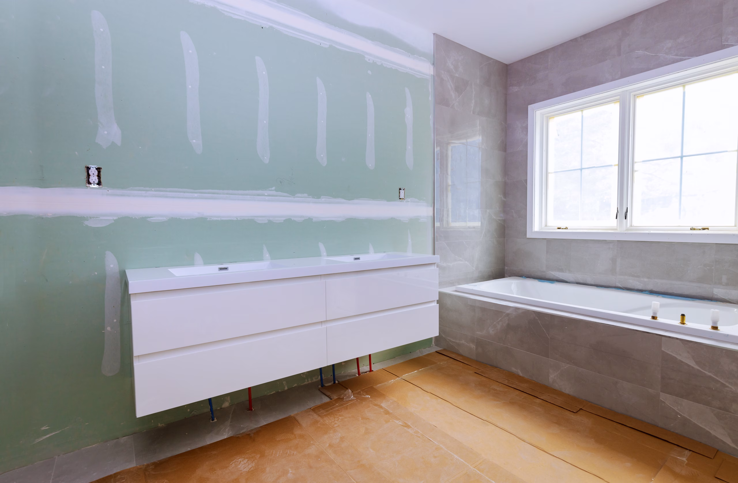 Teilsanierung eines Gäste-WC in Berlin mit neu gefliestem Spritzbereich, modernem Waschbecken und WC